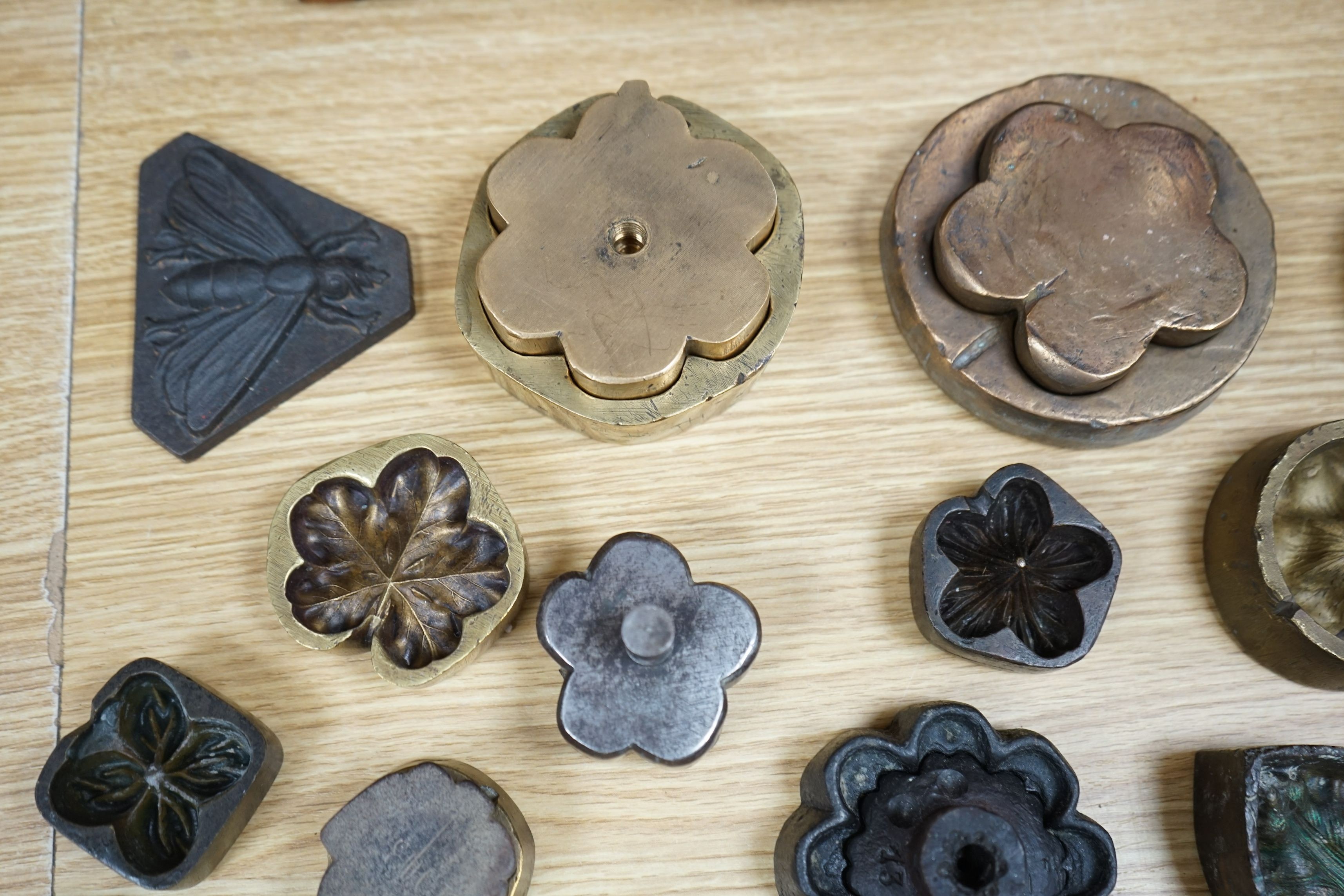 A collection of metal pattern moulds possibly for embossing silk (19) and two other moulds